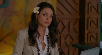 Movie still from “Forgetting Sarah Marshall” (2008), directed by Nicholas Stoller – A woman with a flower in her hair and wearing a white shirt; Close Up shot, High angle