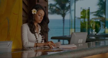Movie still from “Forgetting Sarah Marshall” (2008), directed by Nicholas Stoller – A woman sitting at a table using a laptop computer; Medium shot, Over the shoulder angle