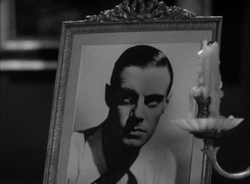 Movie still from “Frankenstein” (1931), directed by James Whale – A black and white photo of a man in a suit and tie; Close Up shot, Low angle