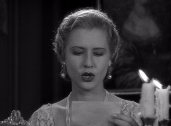 Movie still from “Frankenstein” (1931), directed by James Whale – A young woman holding a piece of paper in front of her face; Close Up shot, Low angle