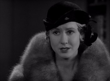 Movie still from “Frankenstein” (1931), directed by James Whale – An old photo of a woman wearing a hat and a fur coat; Close Up shot, Over the shoulder angle