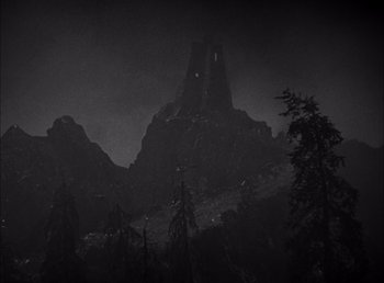Movie still from “Frankenstein” (1931), directed by James Whale – A black - and - white photo of a mountain in the dark; Extreme Wide shot, Low angle