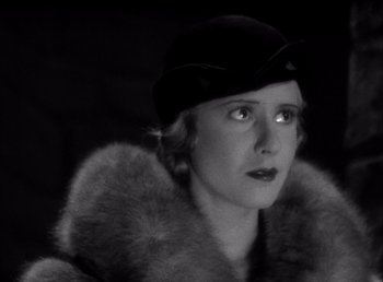 Movie still from “Frankenstein” (1931), directed by James Whale – An old photo of a woman wearing a hat and a fur coat; Close Up shot, Low angle