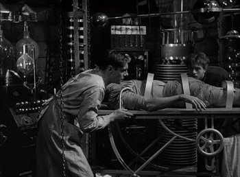 Movie still from “Frankenstein” (1931), directed by James Whale – Two men working in an industrial setting; Medium shot, High angle