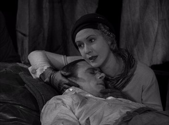 Movie still from “Frankenstein” (1931), directed by James Whale – A man and a woman laying on a bed; Medium shot, High angle