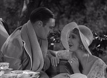 Movie still from “Frankenstein” (1931), directed by James Whale – A man and a woman sitting next to each other on a park bench; Medium shot, High angle