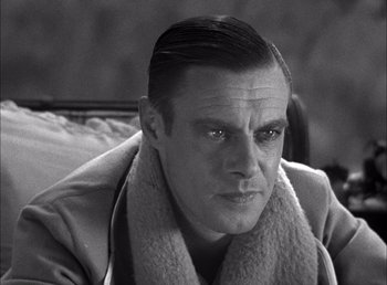 Movie still from “Frankenstein” (1931), directed by James Whale – Black and white photograph of a man in a trench coat; Close Up shot, Over the shoulder angle