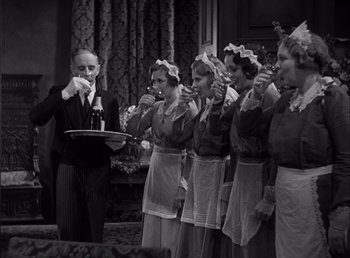 Movie still from “Frankenstein” (1931), directed by James Whale – A group of women in aprons standing next to each other; Medium shot, High angle