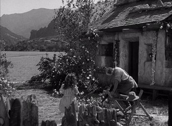 Movie still from “Frankenstein” (1931), directed by James Whale – An old photo of a man and a little girl; Wide shot, High angle