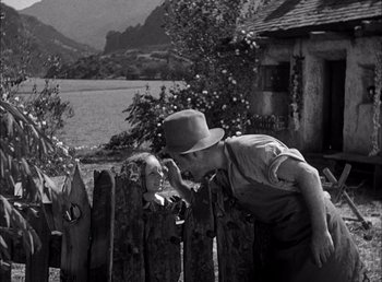Movie still from “Frankenstein” (1931), directed by James Whale – An old photo of a man and a little girl kissing; Wide shot, Over the shoulder angle