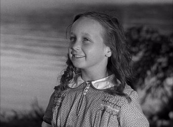 Movie still from “Frankenstein” (1931), directed by James Whale – A young girl smiling for the camera in an old photo; Close Up shot, High angle