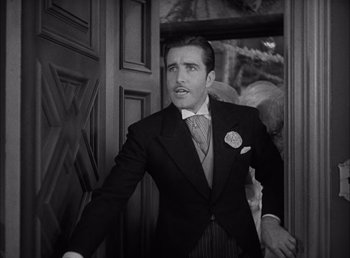 Movie still from “Frankenstein” (1931), directed by James Whale – A black and white photo of a man in a suit; Medium shot, Low angle