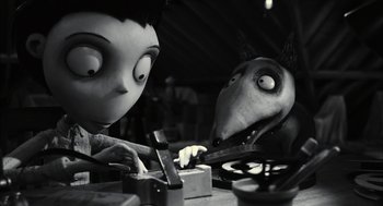 Movie still from “Frankenweenie” (2012), directed by Tim Burton – A black and white photo of a couple of people working on a project; Medium shot, High angle