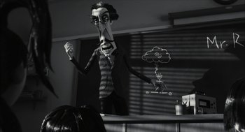 Movie still from “Frankenweenie” (2012), directed by Tim Burton – A black - and - white photo of a man with a strange face; Medium shot, Low angle
