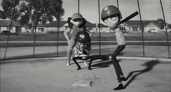 Movie still from “Frankenweenie” (2012), directed by Tim Burton – A couple of people that are standing in the dirt; Wide shot, Low angle