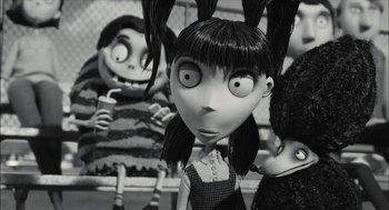 Movie still from “Frankenweenie” (2012), directed by Tim Burton – A black and white photo of a group of people; Close Up shot, Over the shoulder angle