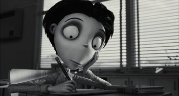 Movie still from “Frankenweenie” (2012), directed by Tim Burton – A black - and - white photo of a cartoon character writing; Close Up shot, High angle