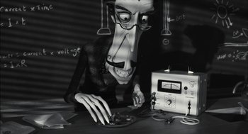 Movie still from “Frankenweenie” (2012), directed by Tim Burton – A man with a strange looking face sitting at a table; Medium shot, Low angle