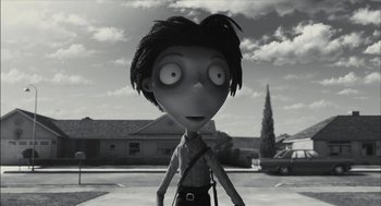 Movie still from “Frankenweenie” (2012), directed by Tim Burton – A black - and - white photo of a person with a bag; Close Up shot, Over the shoulder angle