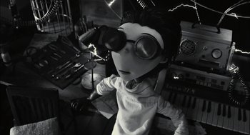 Movie still from “Frankenweenie” (2012), directed by Tim Burton – A black - and - white photo of a person wearing goggles; Medium shot, Low angle