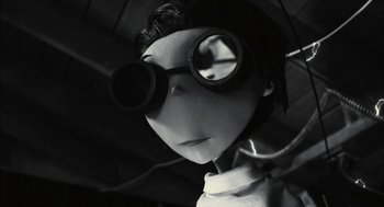 Movie still from “Frankenweenie” (2012), directed by Tim Burton – A black - and - white photo of a person wearing goggles; Close Up shot, Low angle