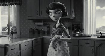 Movie still from “Frankenweenie” (2012), directed by Tim Burton – A black - and - white photo of a woman in a kitchen; Medium shot, Over the shoulder angle
