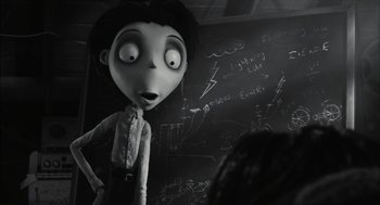 Movie still from “Frankenweenie” (2012), directed by Tim Burton – A black - and - white photo of a woman standing in front of a chalkboard; Medium shot, Over the shoulder angle