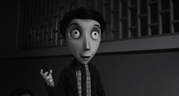 Movie still from “Frankenweenie” (2012), directed by Tim Burton – A black - and - white photo of a character from frankenweenie; Medium shot, Over the shoulder angle