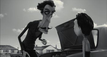 Movie still from “Frankenweenie” (2012), directed by Tim Burton – An old man with a mustache is looking at a car engine; Medium shot, Over the shoulder angle