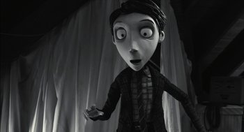 Movie still from “Frankenweenie” (2012), directed by Tim Burton – A black - and - white photo of a woman with a surprised look on her face; Medium shot, Over the shoulder angle