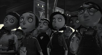 Movie still from “Frankenweenie” (2012), directed by Tim Burton – A group of people standing next to each other in a room; Medium shot, Low angle