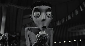 Movie still from “Frankenweenie” (2012), directed by Tim Burton – A black - and - white photo of a character eating a cupcake; Close Up shot, High angle