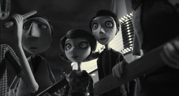 Movie still from “Frankenweenie” (2012), directed by Tim Burton – A black and white photo of a couple of people; Medium shot, Over the shoulder angle