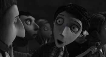 Movie still from “Frankenweenie” (2012), directed by Tim Burton – A black and white photo of a group of people; Close Up shot, Over the shoulder angle