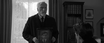 Movie still from “Frantz” (2016), directed by François Ozon – An older man holding a picture of himself; Close Up shot, Over the shoulder angle