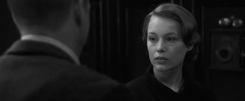 Movie still from “Frantz” (2016), directed by François Ozon – A young woman looking into a mirror while standing next to a man; Close Up shot, Over the shoulder angle