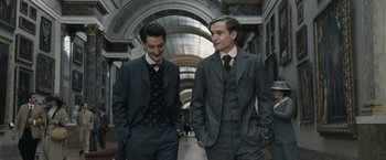 Movie still from “Frantz” (2016), directed by François Ozon – Two men in suits and ties walking down a hall way; Medium shot, Low angle