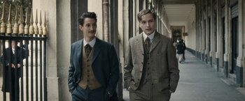 Movie still from “Frantz” (2016), directed by François Ozon – Two men in suits standing next to each other; Medium shot, Over the shoulder angle