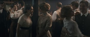 Movie still from “Frantz” (2016), directed by François Ozon – A group of people standing next to each other in a room; Medium shot, Over the shoulder angle