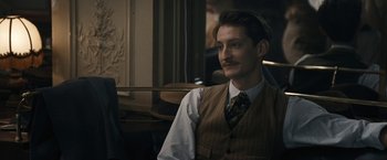 Movie still from “Frantz” (2016), directed by François Ozon – A man with a mustache sitting in a room; Close Up shot, Over the shoulder angle