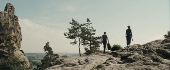 Movie still from “Frantz” (2016), directed by François Ozon – A man walking up a hill holding a suitcase; Extreme Wide shot, Low angle