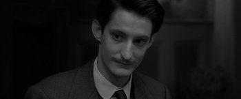Movie still from “Frantz” (2016), directed by François Ozon – A black and white photo of a man with a mustache; Close Up shot, High angle