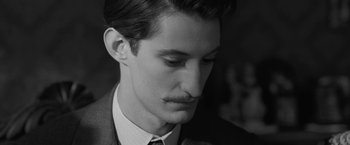 Movie still from “Frantz” (2016), directed by François Ozon – A black and white photo of a man in a suit and tie; Close Up shot, Low angle