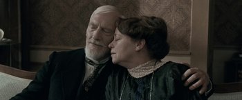 Movie still from “Frantz” (2016), directed by François Ozon – An older man and a younger woman snuggling; Close Up shot, High angle