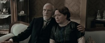 Movie still from “Frantz” (2016), directed by François Ozon – An older man and a younger woman posing for a picture; Medium shot, High angle