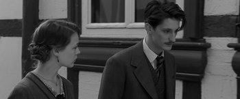 Movie still from “Frantz” (2016), directed by François Ozon – A man and a woman standing next to each other; Medium shot, Over the shoulder angle
