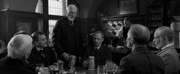 Movie still from “Frantz” (2016), directed by François Ozon – Two men are sitting at a table with beer mugs; Medium shot, Over the shoulder angle