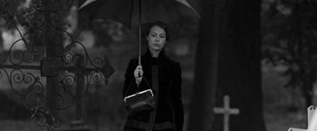 Movie still from “Frantz” (2016), directed by François Ozon – A woman holding an umbrella and a purse; Medium shot, Low angle