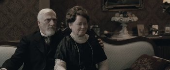 Movie still from “Frantz” (2016), directed by François Ozon – An older man and a woman in a room; Medium shot, Low angle