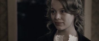 Movie still from “Frantz” (2016), directed by François Ozon – A young woman with a flower in her mouth; Close Up shot, Over the shoulder angle